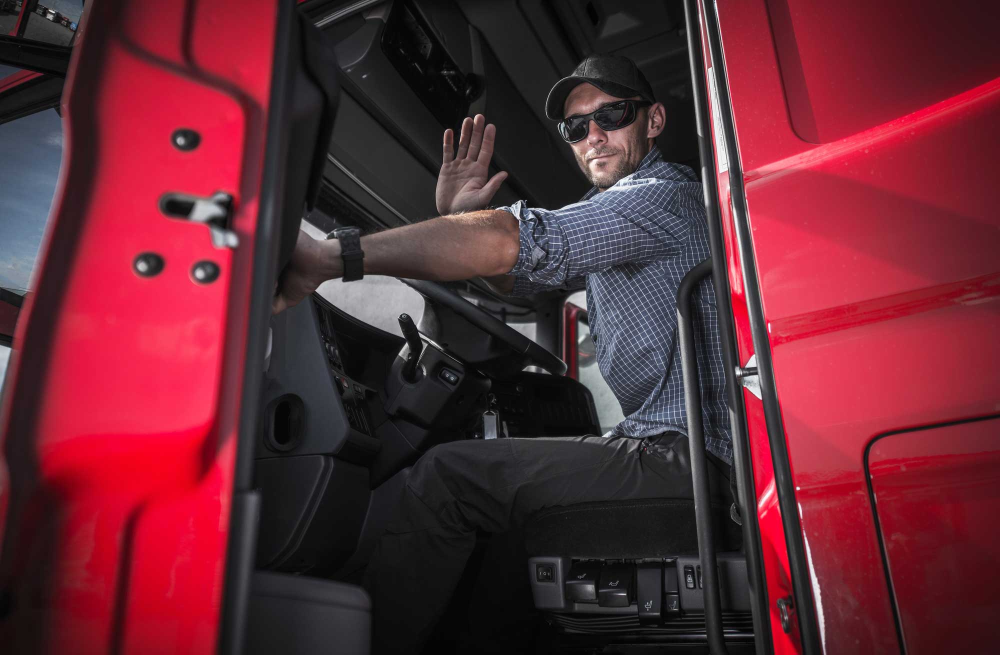 truck driver waving a hand